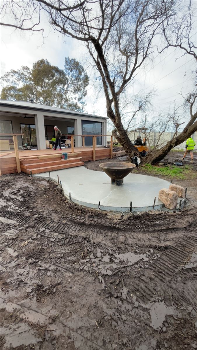 Sunnybank Horticultural crew building a timber deck and circular fire pit base on site